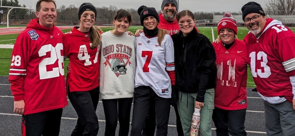 Staff members gather on track during &#34;Turkey Bowl&#34; Powderpuff Football Game