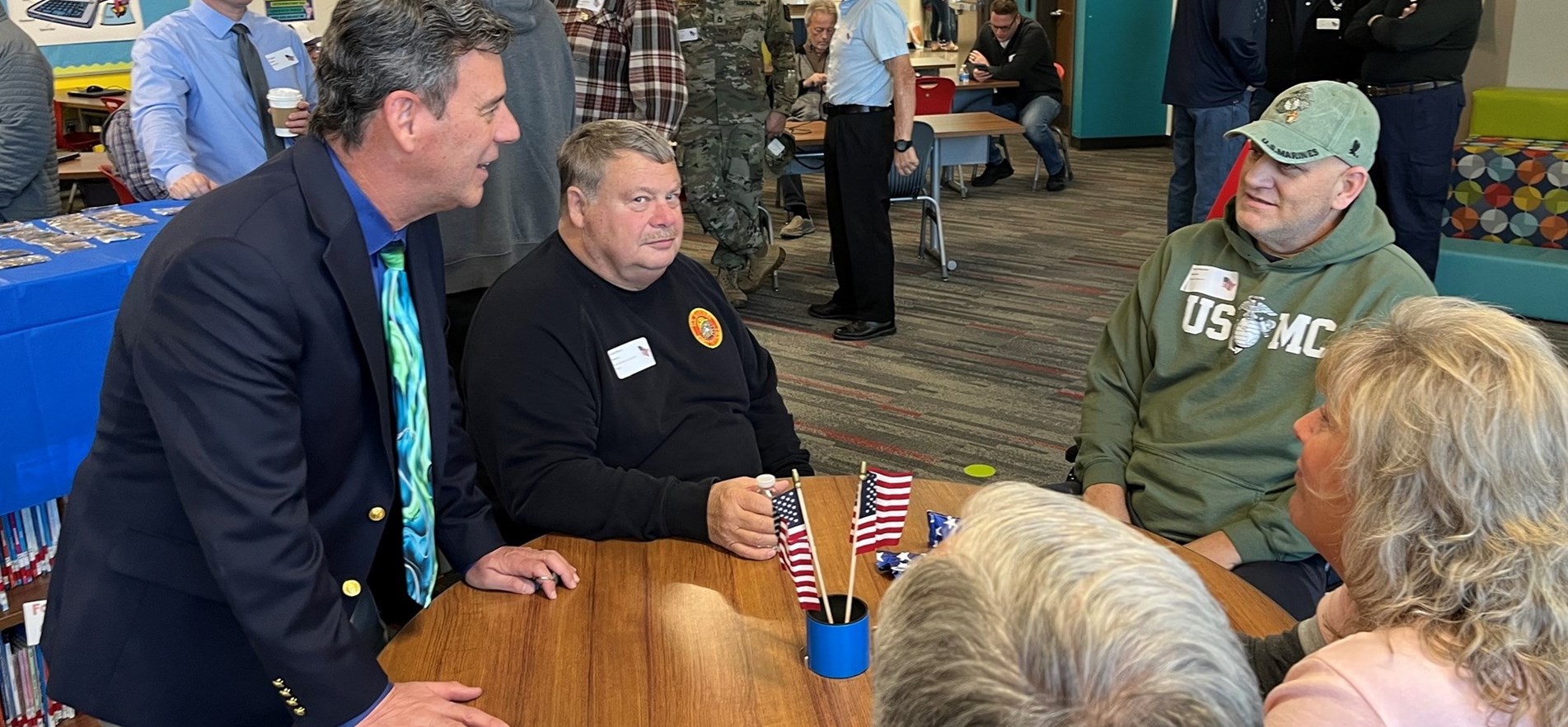 Superintendent Dr. Philip Wagner speaks with Veterans during JES Veterans Day Salute