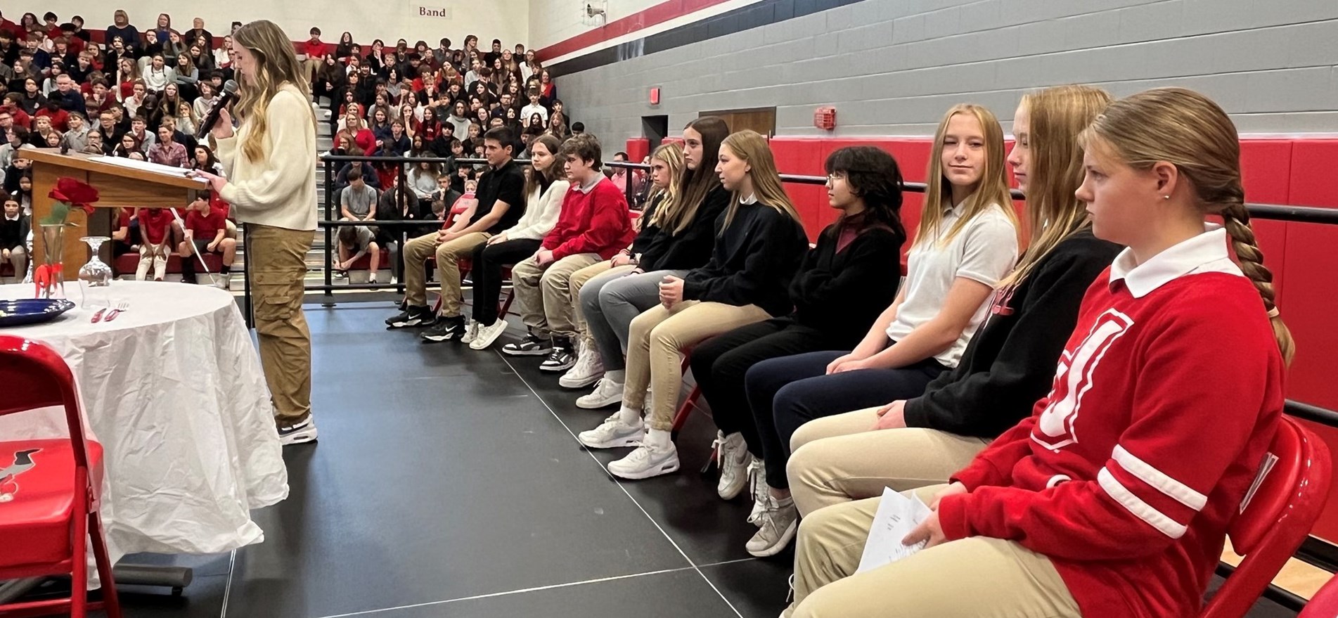 Students gather on reviewing stand in JHS auditorium to pay tribute to local Veterans