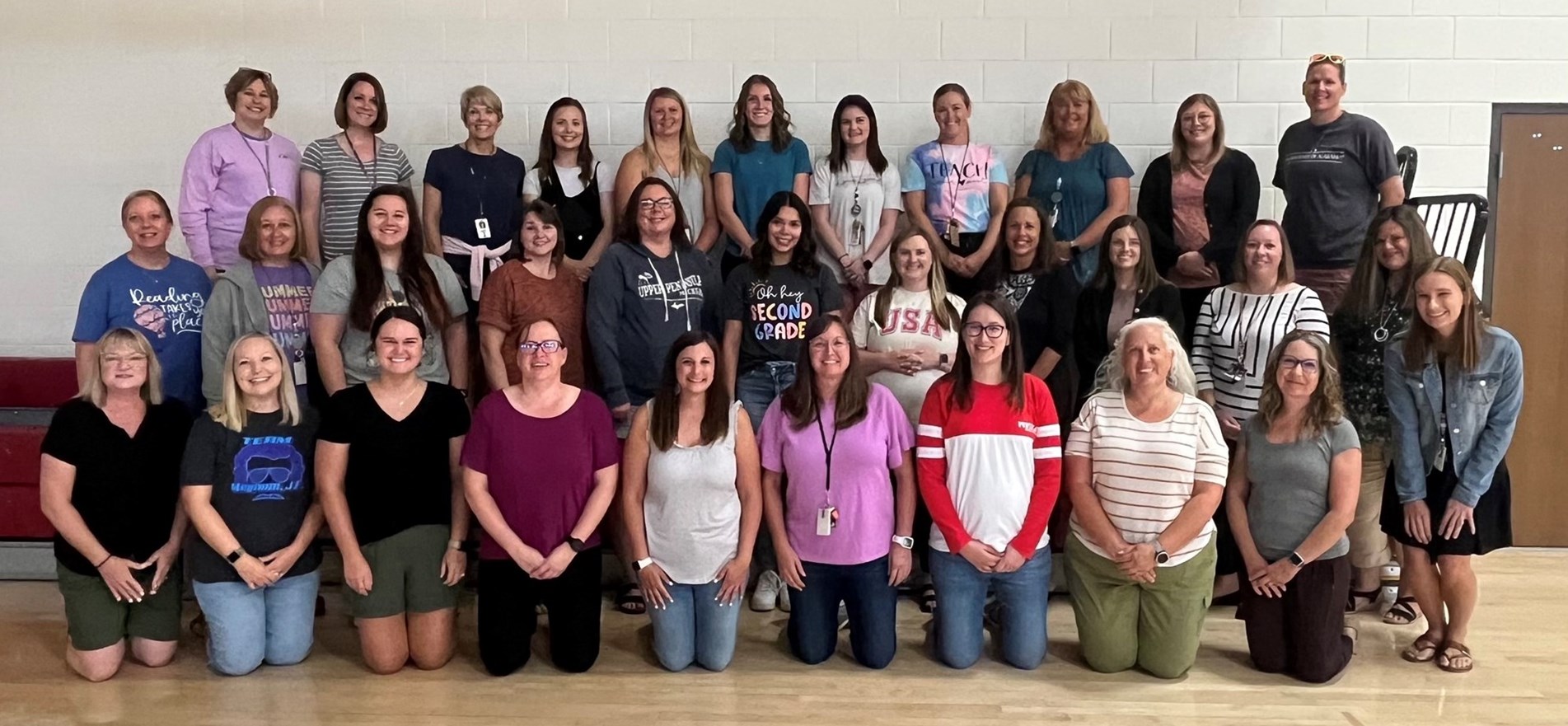 Photo of teaching and administration staff of Johnstown Elementary gathered in gym.