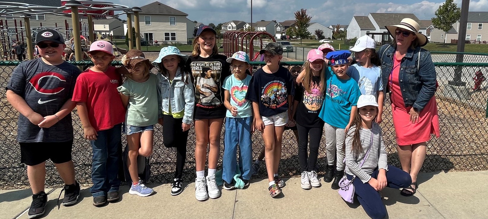 Students and instructor wear hats on playground as part of special spirit week &#34;hat day&#34;