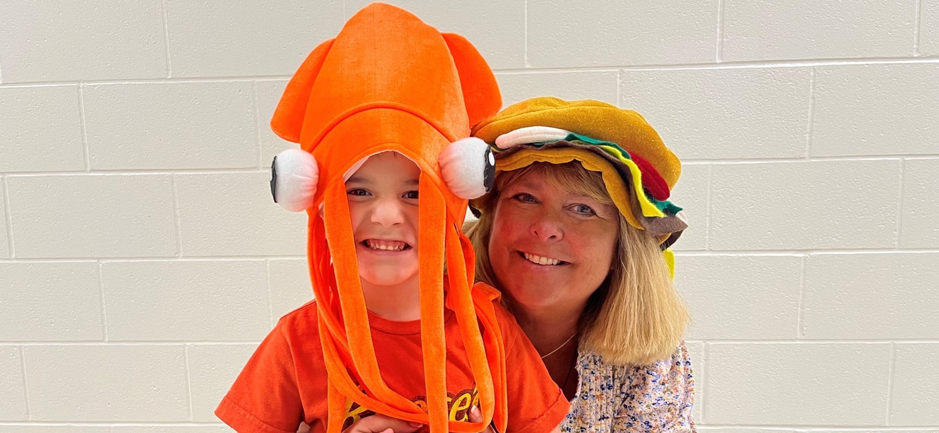 STudent and principal wear funny hats for hat day at Johnstown Elementary