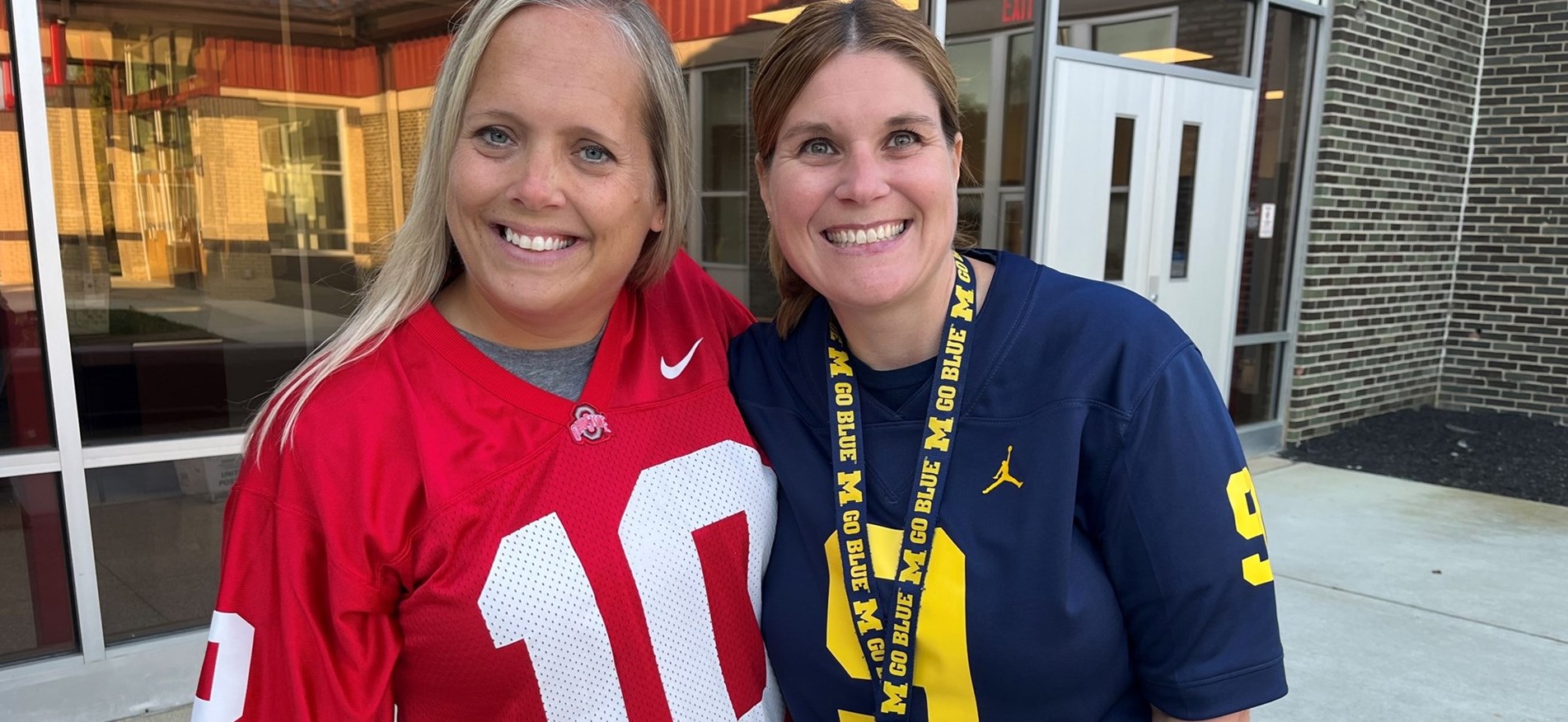 Two staff members were OSU and Michigan gear for sports dress theme day