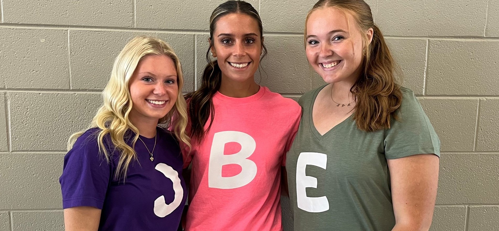 Three students wear matching themed T-shirts and skirts for special Iconic Duo themed dress day