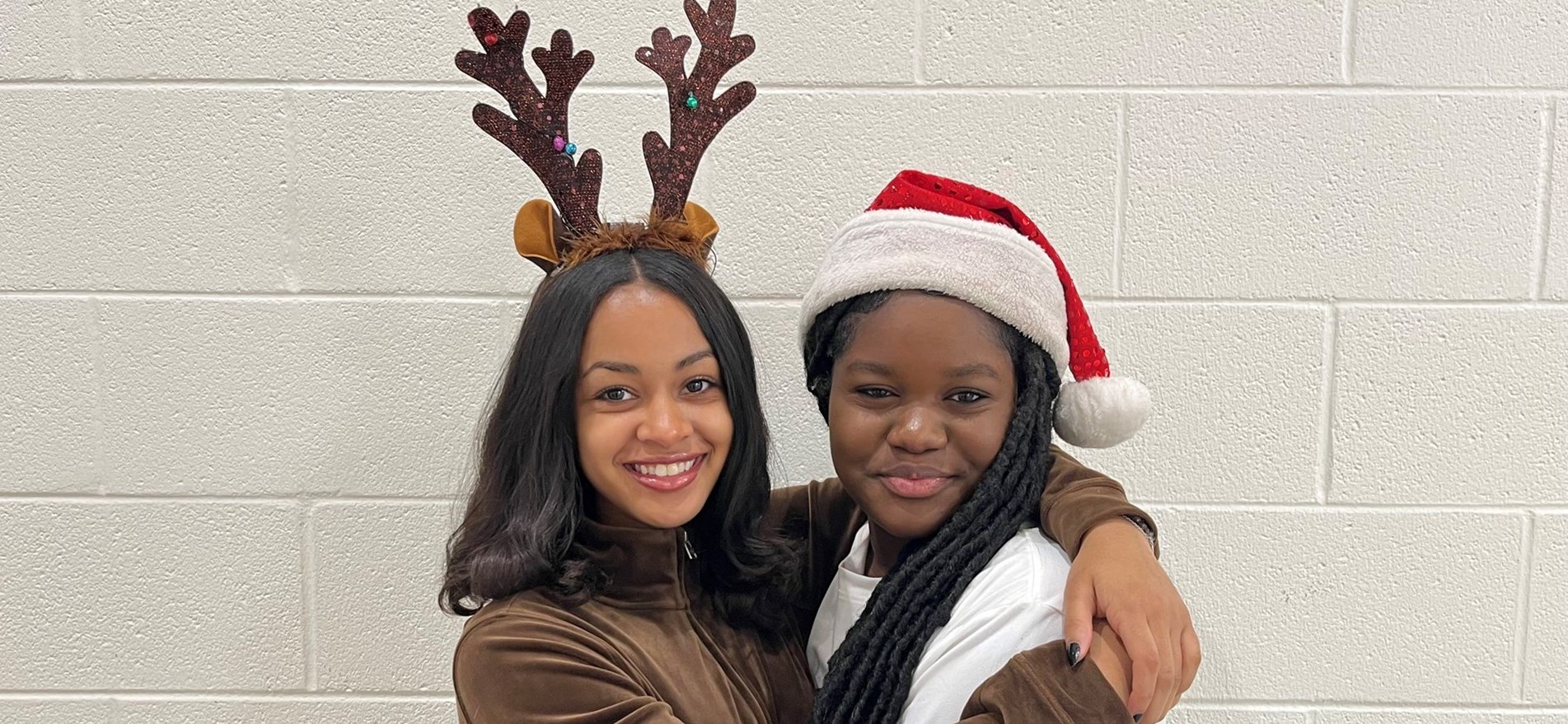 Two students pose in their costums for Iconic Duo themed dress day, one as Santa, the other as a reindeer