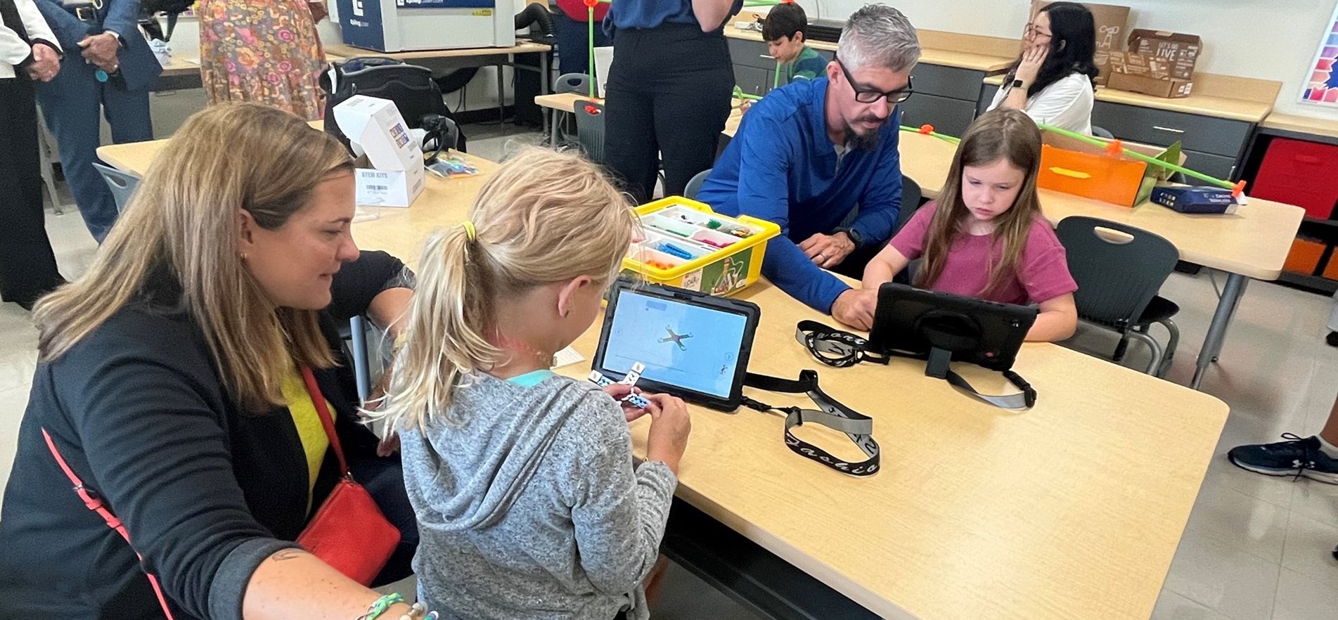 META representatives, others, work with students on devices in new JES STEAM 