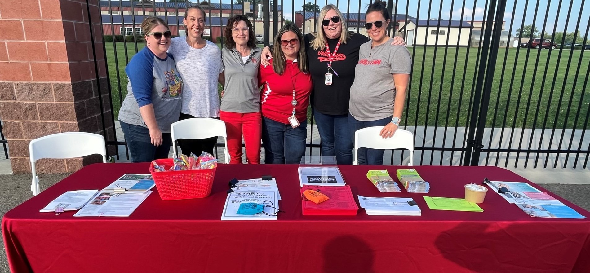 Counseling staff gathers at informational table on night of first varsity football game of 2023 school year