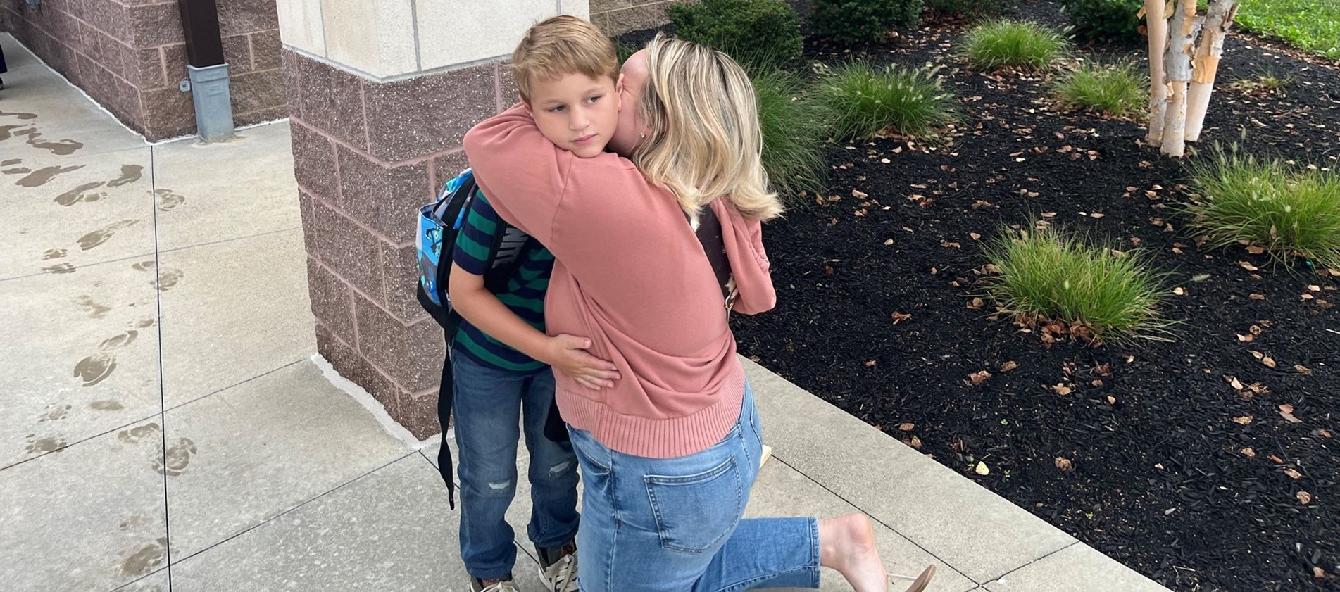 Parent Hugs Child on First Day of School Year 2023-24 before student enters building