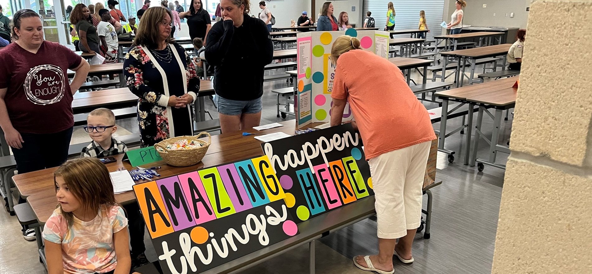 JES parents, staff, children gather around sign during open house event